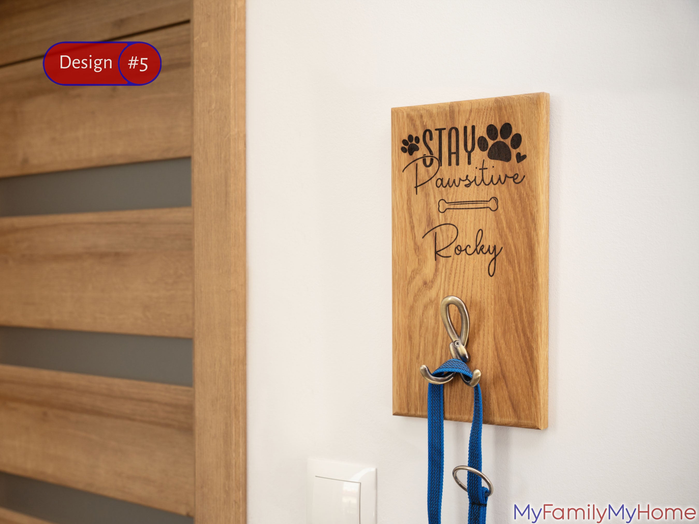 Personalized wooden dog leash holder for wall mount with engraved name 'Rocky' and 'Stay Pawsitive' quote, ideal for pet leash organization.